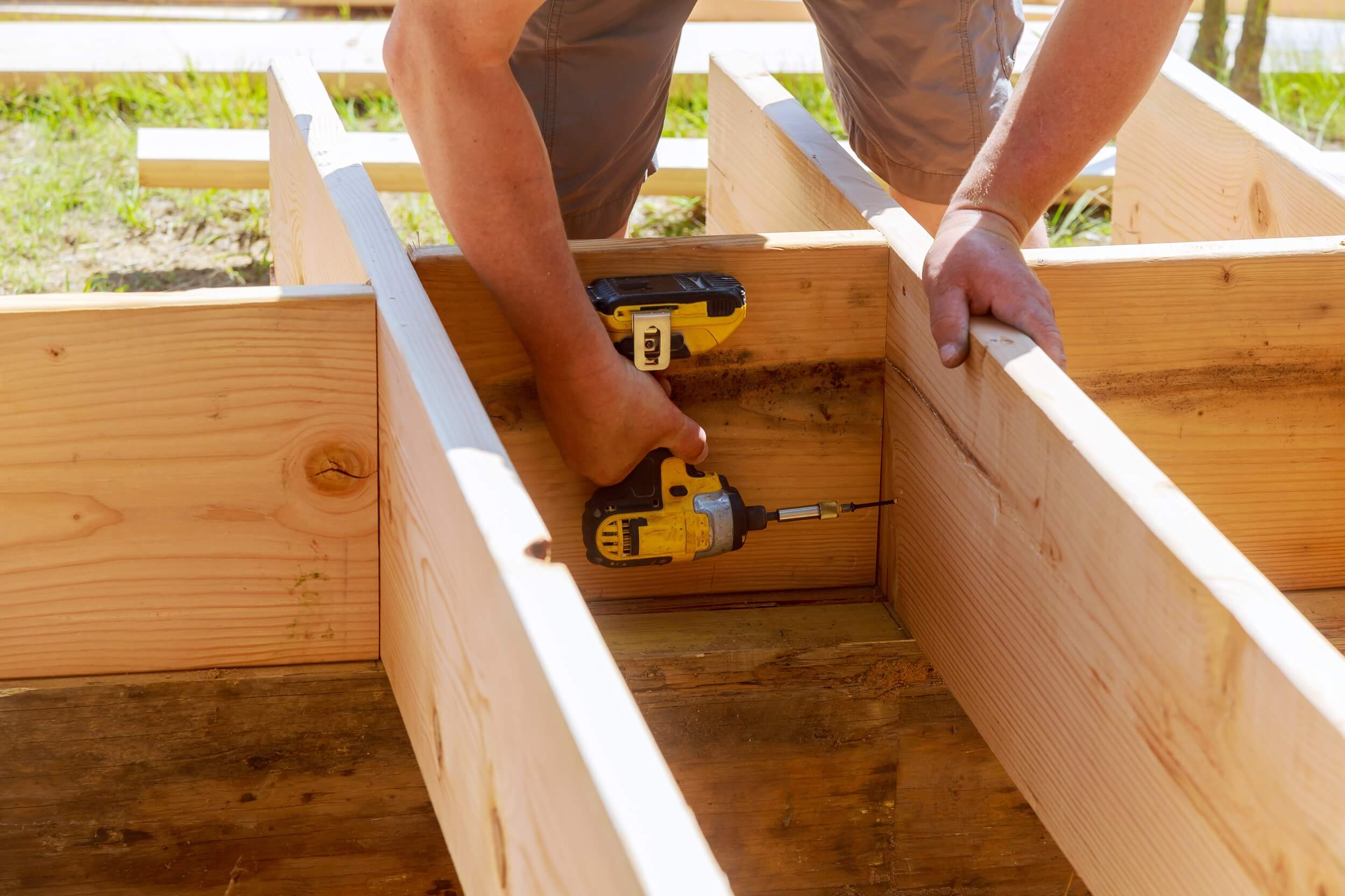 full-length-of-carpenter-drilling-wood-at-construc-2022-08-01-04-00-25-utc